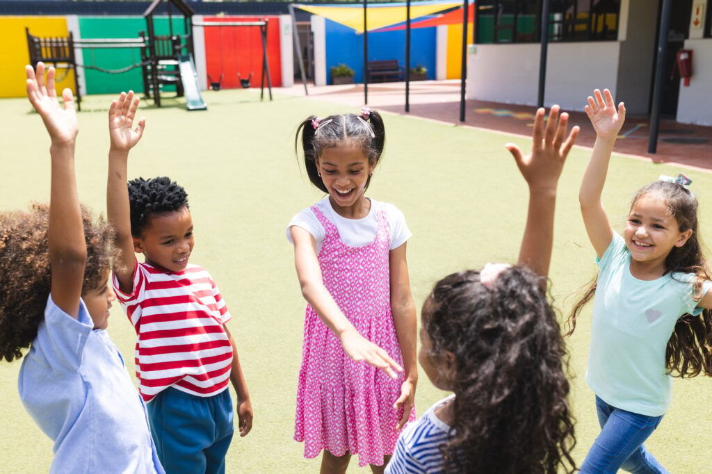 School playground is lively with diverse children playing